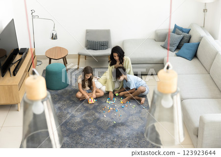 Overhead view, young mum playing building blocks with kids 123923644