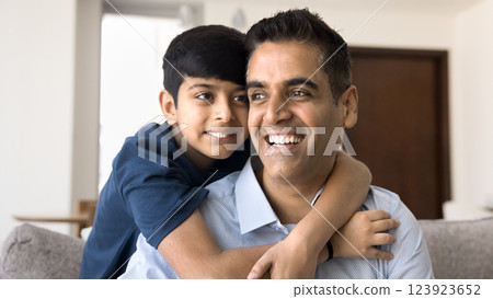 Dad and son hugging, showing strong bond, feeling unconditional love 123923652