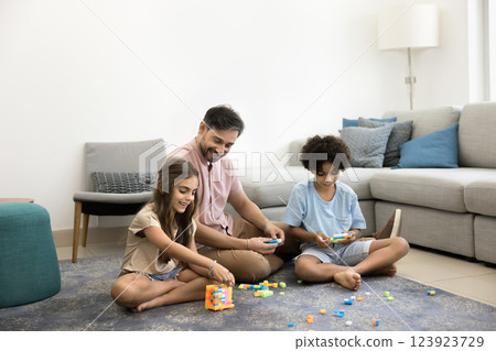 Loving dad spending quality time at home with two kids Loving dad spending quality time at home with two kids 123923729