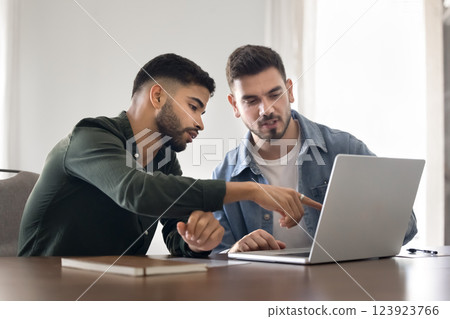 Man presenting idea or commercial offer to colleague using laptop 123923766