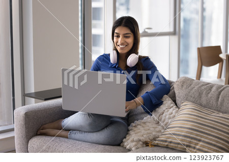 Attractive Indian woman using laptop spend weekend on internet 123923767