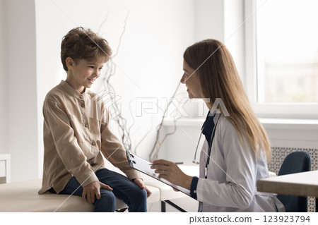 Happy little child patient on meeting with smiling female doctor 123923794