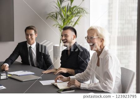 Laughing businesspeople of diverse age having fun on business meeting 123923795