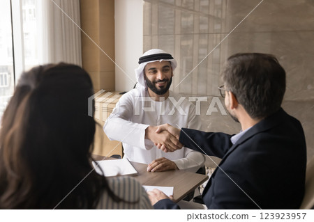 Arabian businessman shake hands, welcoming European colleagues Arabian businessman shake hands, welcoming European colleagues 123923957