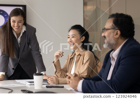 Cheerful diverse business colleagues meeting at table offline 123924046