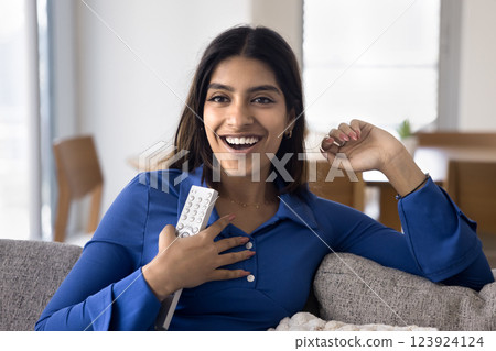 Woman feels thrilled and pleasantly surprised while watching TV show Woman feels thrilled and pleasantly surprised while watching TV show 123924124