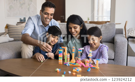 Happy Indian couple play with two kids Happy Indian couple play with two kids 123924212