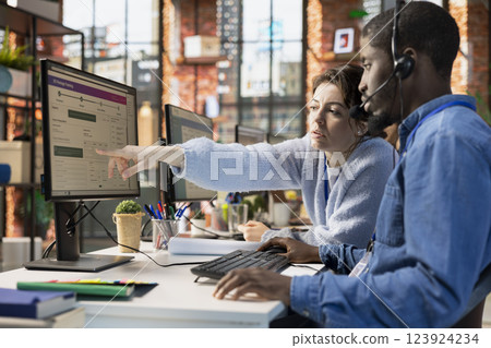 Call center agents collaborating to solve problem for customer, tracking lost shipments in office. Customer center colleagues working together using software to locate clients packages 123924234