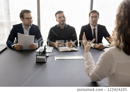Young girl applicant interviewing for position by group of hr Young girl applicant interviewing for position by group of hr 123924295