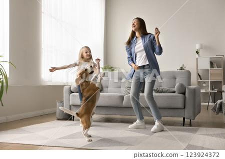 Lively woman dancing with trained dog and little kid Lively woman dancing with trained dog and little kid 123924372