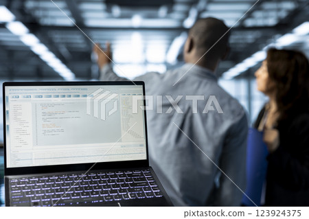 Lines of code on laptop display used by data center technicians to execute security patches. Close up of programming language on notebook used by server hub employees scanning equipment 123924375