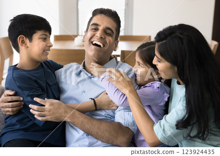 Indian family tickling each other, having fun, laughing on weekend Indian family tickling each other, having fun, laughing on weekend 123924435