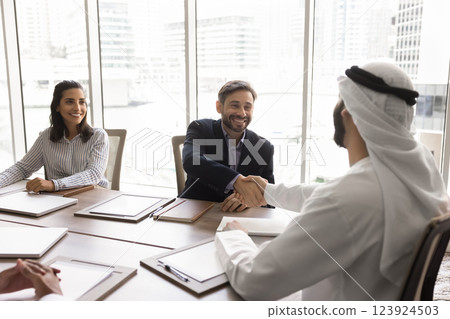 Multicultural business partners closing deal finalize group meeting Multicultural business partners closing deal finalize group meeting 123924503