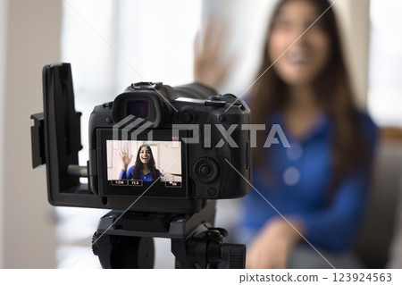 Camera with display screen focused on Indian woman recording videovlog 123924563