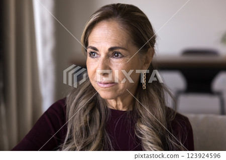 Close up shot of pretty pensive Mexican older woman Close up shot of pretty pensive Mexican older woman 123924596