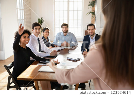 Female seminar participant raising her hand, ask question or voting Female seminar participant raising her hand, ask question or voting 123924614