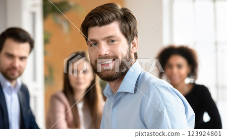 Team leader close up portrait, teammates on background 123924801