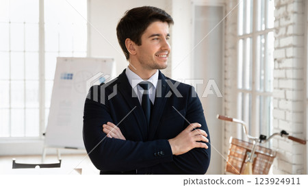 Businessman dressed in formal suit posing confidently in office Businessman dressed in formal suit posing confidently in office 123924911