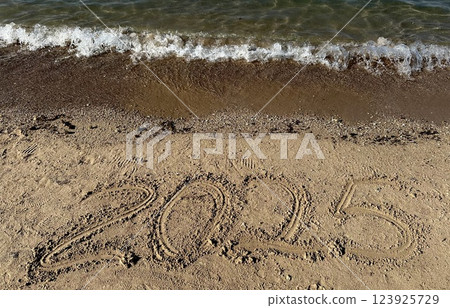Year 2025 Written in Sand. Christmas  123925729