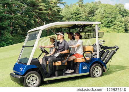 Golfer man and woman riding a golf cart on a golf course Golfer man and woman riding a golf cart on a golf course 123927848