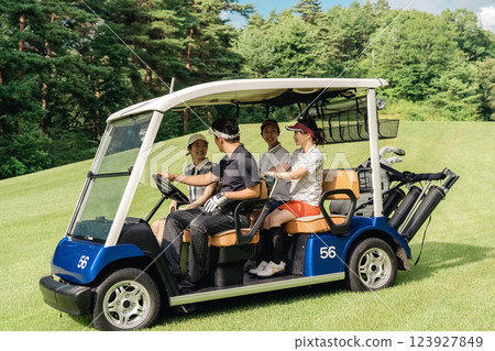 Golfer man and woman riding a golf cart on a golf course Golfer man and woman riding a golf cart on a golf course 123927849