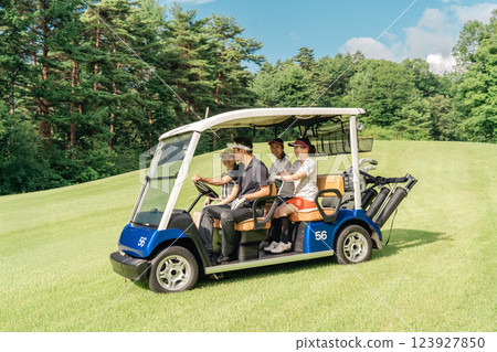 Golfer man and woman riding a golf cart on a golf course 123927850