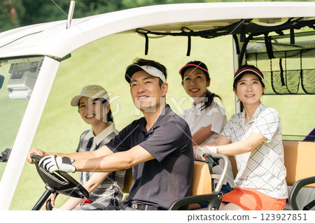 Golfer man and woman riding a golf cart on a golf course Golfer man and woman riding a golf cart on a golf course 123927851