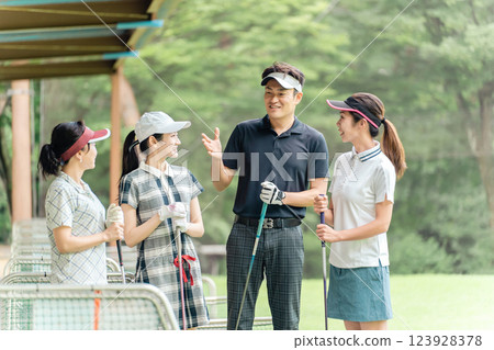 Golfer men and women taking golf lessons at the golf course Golfer men and women taking golf lessons at the golf course 123928378