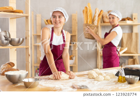 Women bakers making bread in a bakery 123928774