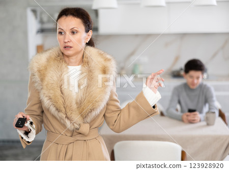 Single mother goes to party and leaves her teenage son alone at home Single mother goes to party and leaves her teenage son alone at home 123928920