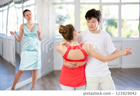 Girl and boy dancing slow ballroom dance in choreography studio 123929042