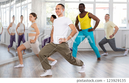 Group of people warming up before dance class Group of people warming up before dance class 123929135