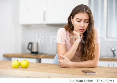 Distressed young woman reading a message on a mobile phone 123929263