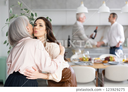 Happy young woman welcoming old lady at home Happy young woman welcoming old lady at home 123929275
