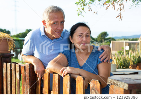 Portrait of positive mature couple in garden outdoors 123929386