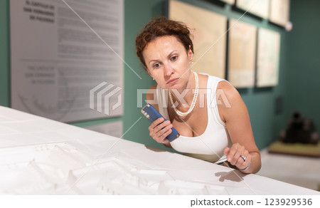 Woman looking at contemporary art sculpture installation in museum 123929536