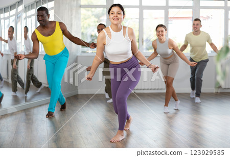 Asian girl with team of like-minded multinational people learn to elements of hip hop dance 123929585