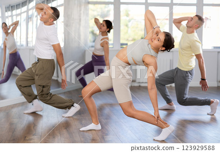 European girl with team of like-minded multinational people learn to elements of electro dance European girl with team of like-minded multinational people learn to elements of electro dance 123929588