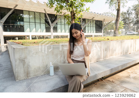 Sustainable lifestyle. Young woman working on her laptop while enjoying nature. Sustainable lifestyle. Young woman working on her laptop while enjoying nature. 123929862