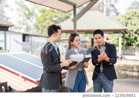 Sustainable business. Professionals examining potential solar solutions outdoors. 123929881