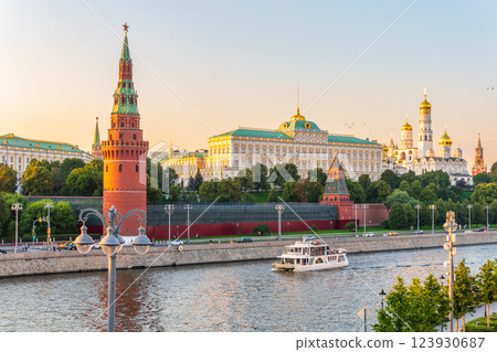 View of Kremlin with Vodovzvodnaya tower, Grand Kremlin Palace from repaired Bolshoy Kamenny Bridge in Moscow city on sunny summer day. Cruise ship sails on the Moscow river 123930687