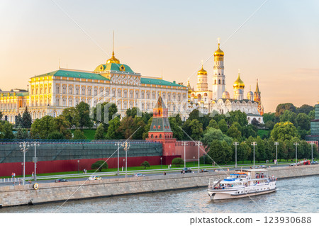 View of Kremlin with Vodovzvodnaya tower, Grand Kremlin Palace from repaired Bolshoy Kamenny Bridge in Moscow city on sunny summer day. Cruise ship sails on the Moscow river 123930688