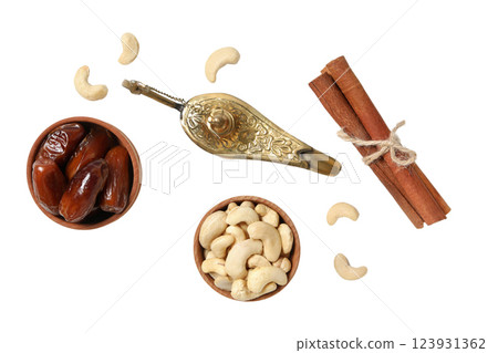 PNG, Ramadan. Golden lamp with dates, cinnamon and cashews, isolated on white background. PNG, Ramadan. Golden lamp with dates, cinnamon and cashews, isolated on white background. 123931362