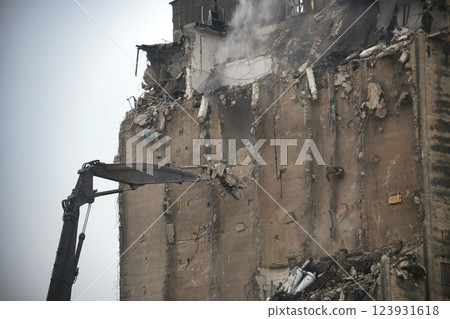 Demolition Process of an Industrial Building Using Excavator Equipment 123931618
