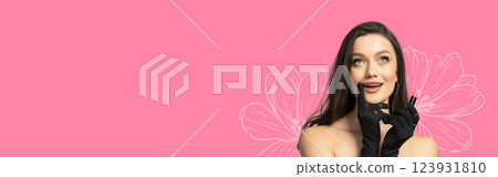 8 March, international women's day, surprised happy woman in black gloves and with lipstick in her hands on a pink background, with space for text 123931810