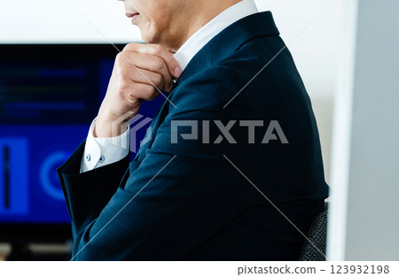 A business man who thinks in front of a personal computer A business man who thinks in front of a personal computer 123932198