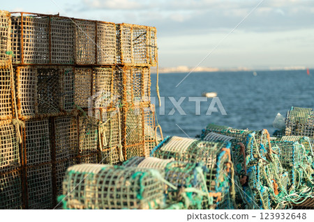 Stack of lobster traps by the sea on coastal Stack of lobster traps by the sea on coastal 123932648