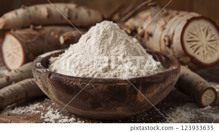 Cassava flour and roots in a bowl. Generative AI 123933635