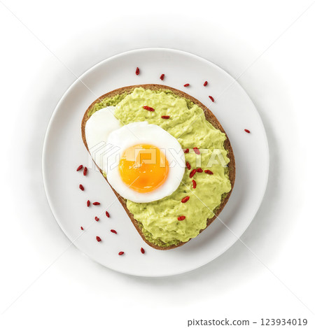 Smashed Avocado on Toast - Creamy mashed avocado spread on toasted bread, often topped with poached eggs, herbs, and chili 123934019