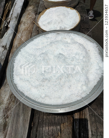kusamba village, bali, indonesia, traditional sea salt maker, Fetching seawater directly from the sea and drying it on a wooden tool under the sun. 123934657